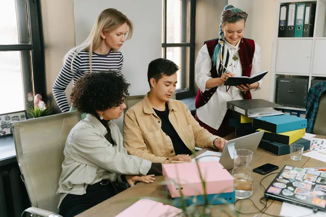A group of young professionals engaging in a collaborative meeting in a modern office setting. Product marketing careers: a practical guide for 2027